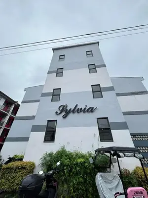 a building with a sign on the side of it at Jade Condo Netflix Wifi Karaoke with Cinema Projector in Imus