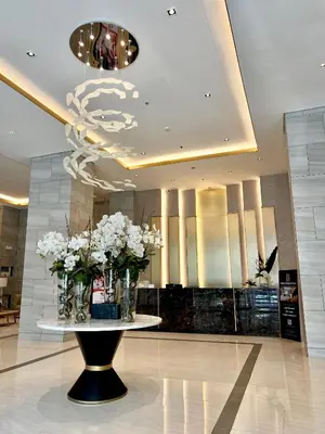 a lobby with a table with vases of flowers at Kabina Suites at Fame Residences in Manila