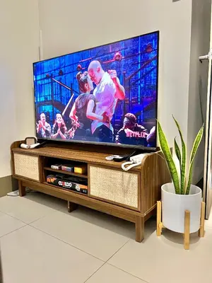 a flat screen tv sitting on top of a wooden entertainment center at Kabina Suites at Fame Residences in Manila