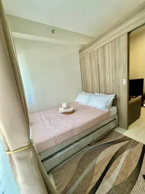 a bedroom with a bed with a hat on it at Kabina Suites at Fame Residences in Manila