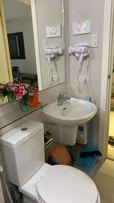 a bathroom with a white toilet and a sink at AFFORDABLE STAYCATION NEAR Airport in Manila