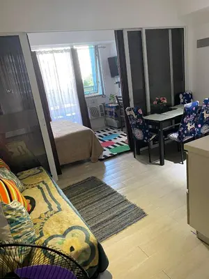 a living room with a couch and a table in it at AFFORDABLE STAYCATION NEAR Airport in Manila