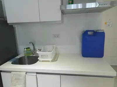 a kitchen counter with a sink and a blue container at AFFORDABLE STAYCATION NEAR Airport in Manila