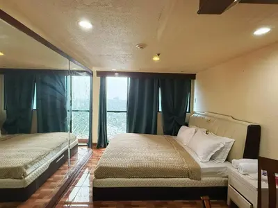 a bedroom with two beds and a window at mooring in Manila