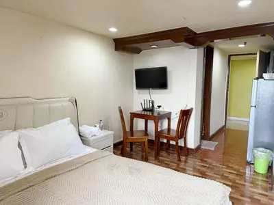 a bedroom with a bed and a table with chairs at mooring in Manila