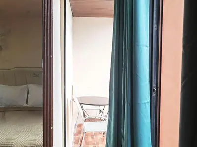 a room with a table and a chair outside a window at mooring in Manila