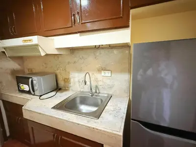 a small kitchen with a sink and a microwave at mooring in Manila