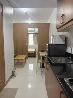 a kitchen with a sink and a counter top at The Fortress at SMDC The Lush Residences in Manila
