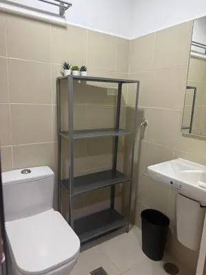 a bathroom with a toilet and a sink at The Fortress at SMDC The Lush Residences in Manila