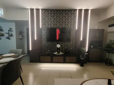 a living room with a wall with a red letter on it at Jpad Suites in Manila