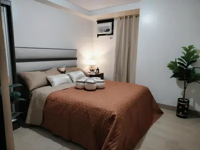 a bedroom with a bed with two jars on it at Jpad Suites in Manila