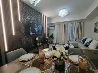 a living room with a table and a couch at Jpad Suites in Manila