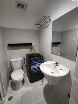 a bathroom with a toilet and a sink at Lornas Staycation in Manila