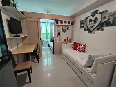 a living room with a couch and a table at Lornas Staycation in Manila