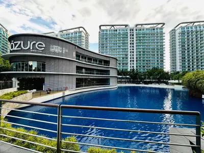 a building with a large pool in front of it at 1BR Condotel in Azure Urban Resort near NAIA #TRO4 in Manila