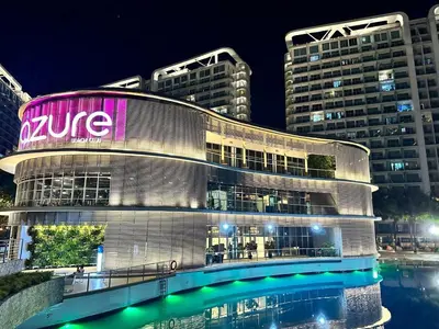 a large building with a sign on it at night at 1BR Condotel in Azure Urban Resort near NAIA #TRO4 in Manila