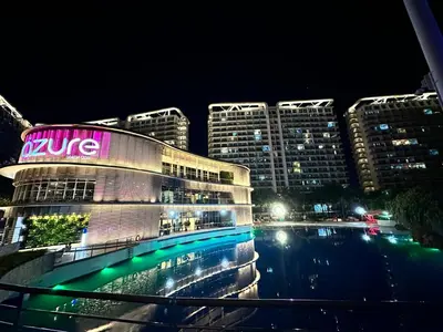 a building with a neon sign on it at night at 1BR Condotel in Azure Urban Resort near NAIA #TRO4 in Manila