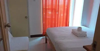 a room with a bed with a roll of toilet paper on it at CJ Chateau Elysse in Manila