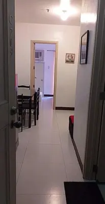a hallway with a dining room and a dining table at CJ Chateau Elysse in Manila