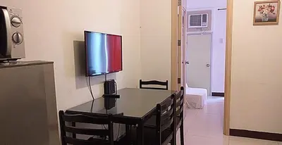 a room with a table with a television on top of it at CJ Chateau Elysse in Manila