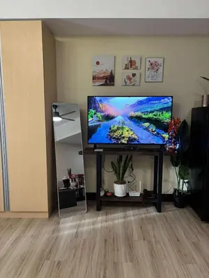 a flat screen tv sitting on a stand in a living room at Venice Luxury Residences Emanuele in Manila