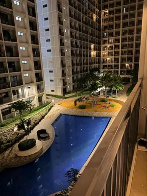 a swimming pool in the middle of a building at Relaxing 1BR Condo near MOA & NAIA with WiFi, PS4, Karaoke in Manila