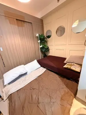 a bedroom with a bed in a room at Relaxing 1BR Condo near MOA & NAIA with WiFi, PS4, Karaoke in Manila