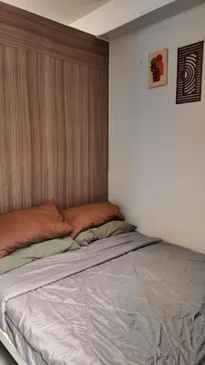 a bed in a room with a large window at Staycation near NAIA, MOA with PS4, Netflix & Karaoke in Manila