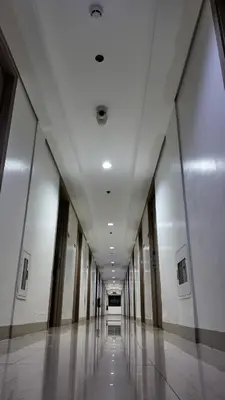 an empty hallway of a building with a long corridor at Staycation near NAIA, MOA with PS4, Netflix & Karaoke in Manila