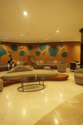 a living room with couches and a table in a room at Staycation near NAIA, MOA with PS4, Netflix & Karaoke in Manila