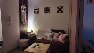 a living room with a couch and a coffee table at Staycation near NAIA, MOA with PS4, Netflix & Karaoke in Manila
