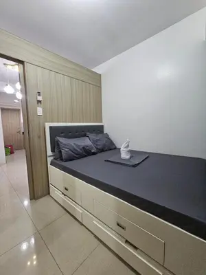 a bedroom with a large bed in a room at Shore Residences Tower D Viann in Manila