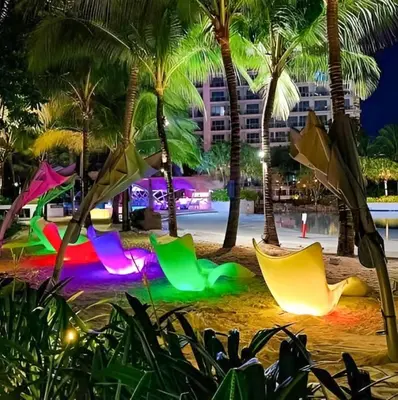 a beach with palm trees and colorful chairs at CASA VANA in AZURE STAYCATION in Manila