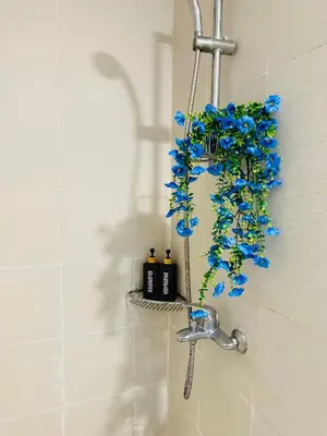 a bathroom with a shower with blue flowers in it at CASA VANA in AZURE STAYCATION in Manila