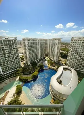 arial view of a pool in a resort with tall buildings at CASA VANA in AZURE STAYCATION in Manila