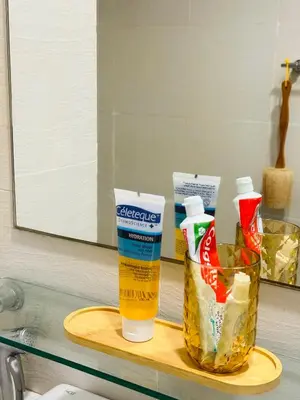 a shelf with a bottle of toothpaste and a container of food at CASA VANA in AZURE STAYCATION in Manila