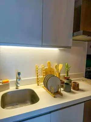 a kitchen counter top with a sink and a kitchen counter at CASA VANA in AZURE STAYCATION in Manila