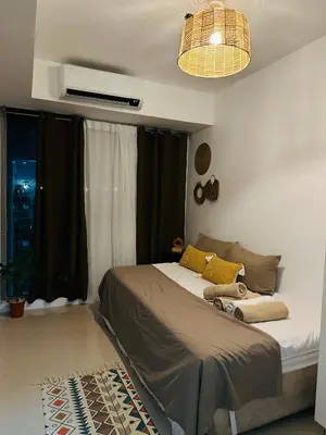 a bedroom with a bed and a window at CASA VANA in AZURE STAYCATION in Manila