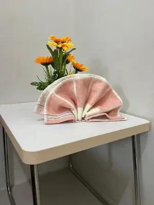 a table with a vase of flowers on it at Sea Residences Elegant Place by Bella in Manila