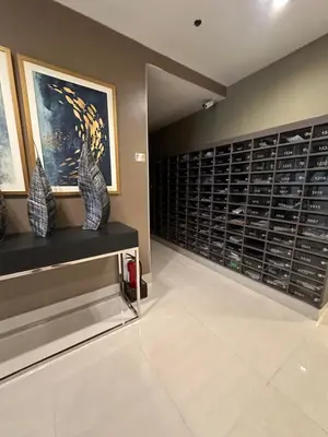 a wine cellar with a large wall of wine cabinets at Sea Residences Elegant Place by Bella in Manila