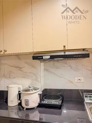 a kitchen counter with a coffee maker and a toaster at Wooden White in Manila
