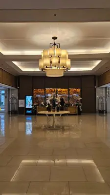 a large lobby with a table and a chandelier at The Executive Suites by PJTai Realty Shell002 - 1BR in Manila
