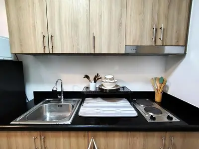 a kitchen with a sink and a counter top at PROMO Modern Boho Chic Condo Near MOA, Manila Bay in Manila