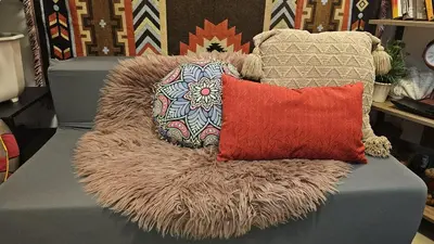 a pile of pillows sitting on top of a couch at PROMO Modern Boho Chic Condo Near MOA, Manila Bay in Manila