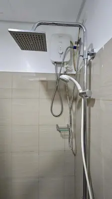 a shower in a bathroom with a shower head at PROMO Modern Boho Chic Condo Near MOA, Manila Bay in Manila