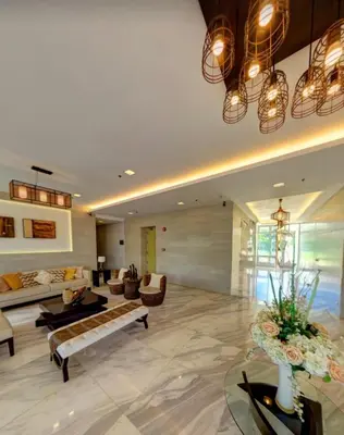 a large living room with couches and a couch at The Global Nest at Anuva Modern 1BR with Pool in Manila