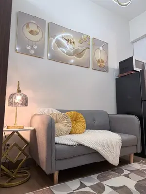 a living room with a couch and a table at 2 BR Modern Apartment Near the Airport in Manila