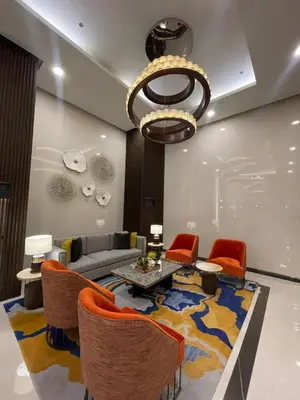 a living room with a couch and a table and chairs at Sunset Retreat - 4 Bedroom Home near Solaire 14pax in Manila