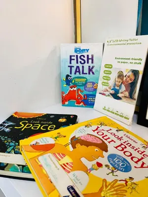 three childrens books sitting on a table at Azure Destiny's Suites 1409 in Manila