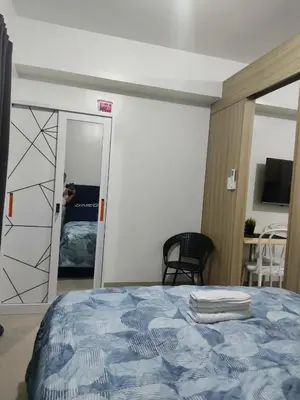 a person taking a picture of a bedroom with a bed at Shore 2 Residences Tower 1 JayDa in Manila